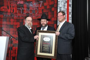 R' Shmuli Margulies and R' Natan Rosentaler presenting Rabbi Yaakov Gutterman with Certificate of Honor